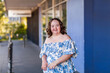 © Austockphoto - Happy smiling portrait of young lady with down syndrome outside shops