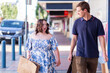 © Austockphoto - Young female client and disability worker talking as they walk down street beside shops