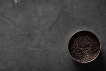 Spice Tin Of Black Mustard Seeds On A Dark Marble Background