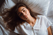 © wetzkaz - a young adult woman lies in bed and wants to sleep, top view, bedded on white pillows. Generative AI