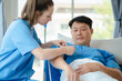© NINENII - Female doctor having blood pressure test male at the clinic in the morning.