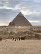 Tourists walking around Great Sphinx and Pyramid of Khafre, Giza plateau Cairo, Egypt