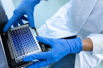 Female researcher carrying out research experiment in a chemistry lab