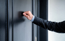 Close Up Of Young Man Knocking On The Door