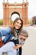© Xavier Lorenzo - Happy senior couple having fun taking selfie portrait during vacation. Mature male and female tourist enjoying holidays in Barcelona. Happy people lifestyle
