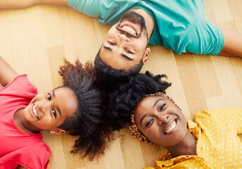 Wall Mural - child daughter family happy mother father floor lying down  fun together girl cheerful group team teamwork home black