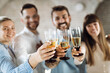 © Goran - Close up of group of business people having fun and toasting with white wine