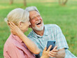 © Lumos sp - woman man senior couple together elderly smartphone online communication cellphone mobile phone using device active happy park internet connection technology wireless texting