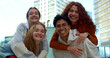 © gonzagon - Group of smiling diverse teenage students having fun looking at camera in a city.Happy people looking at the camera.