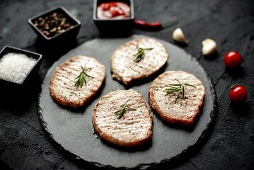 Poster - grilled pork steaks on stone background 