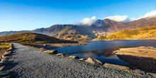 The Causeway That Takes The Miners Track Across Llyn Llydaw At Its Eastern End In The Snowdonia National Park, North Wales.