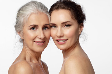 two women of different ages and skin types take care of their facial skin look at the camera