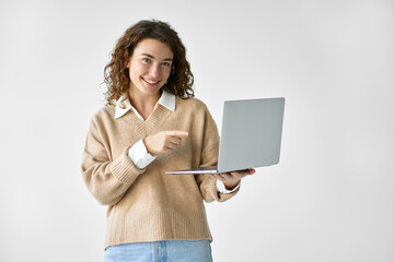 Young happy woman model student pointing at laptop presenting elearning course, holding computer advertising software for education, job search websites standing isolated on white background.