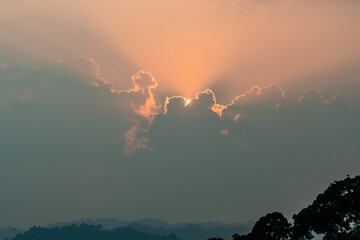 Wall Mural - Divine glow through the clouds of the evening warm sun. Concept of peace and happiness.