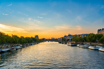 Poster - Seine river at sunrise overlooking Passerelle Leopold Sedar Senghor footbridge and rooftop of Notre  Dame cathedral in Paris. France