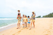 © CandyRetriever  - Group of Asian Multi-Generation family in casual clothing enjoy and fun outdoor lifestyle walking and playing together at tropical beach during travel island ocean at sunset on summer holiday vacation