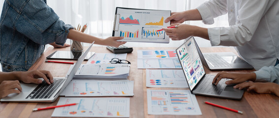Leinwandbilder - Panorama shot analyst team utilizing BI Fintech to analyze financial report with laptop. Businesspeople analyzing BI power dashboard displayed on laptop screen for business insight. Scrutinize