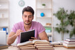 © Elnur - Young male student sitting in the classroom