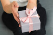 © PanArt - Hands holding craft paper gift box with as a present