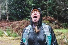 Woman With Mouth Open Catching Snow Flakes On Tongue