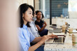© Cavan Images - Female entrepreneur working on laptop while sitting in coffee shop