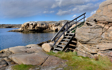 Wall Mural - wooden stairecase  along the sea of  the Swedish rocky coast.