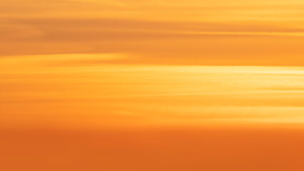 Panorama of the orange evening sky. Real majestic sunrise sundown sky background without birds.