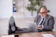 © Elnur - Old male employee working in the office