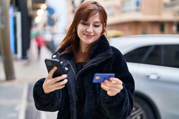 Poster - Young woman using smartphone and credit card at street