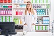 © Krakenimages.com - Young beautiful hispanic woman pharmacist smiling confident standing at pharmacy