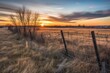 © Lasvu - Dawn over untamed prairie grasslands in Alberta, Canada, behind a wooden barbed wire fence. Generative AI