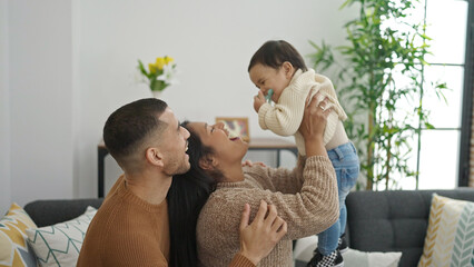 Poster - Couple and son hugging each other sitting on sofa at home