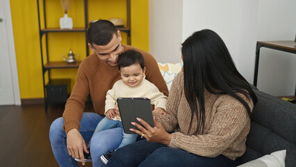 Poster - Couple and son using touchpad sitting on sofa at home