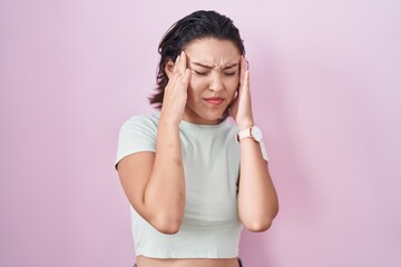 Sticker - Hispanic young woman standing over pink background with hand on head, headache because stress. suffering migraine.