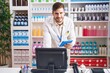 © Krakenimages.com - Young caucasian man pharmacist using computer and touchpad at pharmacy