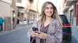 © Krakenimages.com - Young blonde woman smiling confident using smartphone at street