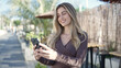 © Krakenimages.com - Young blonde woman smiling confident using smartphone at coffee shop terrace