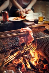 Poster - Vertical closeup of delicious meat on a grill during a gathering in a backyard