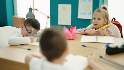 Sticker - Group of kids students sitting on table drawing on notebook at classroom