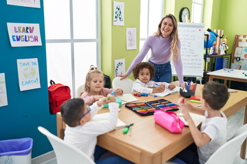 Poster - Woman and group of kids having lesson sitting on table at classroom