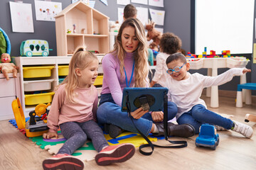 Sticker - Woman and group of kids having lesson using touchpad at kindergarten