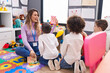 © Krakenimages.com - Woman and group of kids having vocabulary lesson with word cards at kindergarten