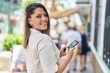 © Krakenimages.com - Young hispanic woman smiling confident using smartphone at street