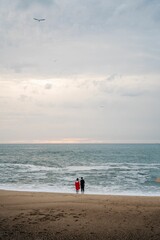 Wall Mural - Couple in love standing beach looking at sea ocean porto portugal