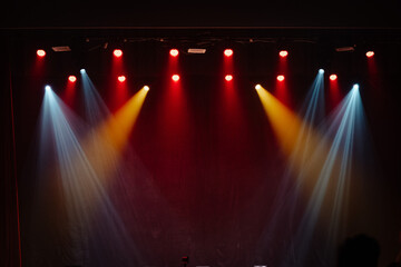 Empty stage lit up in various lights