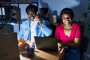 Canvas Print - African american man and woman business workers using laptop talking on the telephone at office