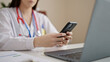 Young beautiful hispanic woman doctor using laptop and smartphone at clinic