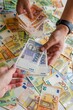 © Lucija Kanižaj/Wirestock Creators - Human hand holding the Croatian kuna banknotes against the background of Euro and USD banknotes
