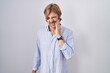 © Krakenimages.com - Caucasian man with mustache standing over white background touching mouth with hand with painful expression because of toothache or dental illness on teeth. dentist