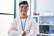 © Krakenimages.com - Young hispanic man scientist smiling confident standing with arms crossed gesture at laboratory